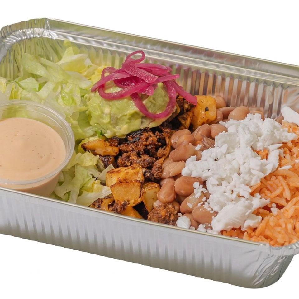 Takeout tray filled with Mexican-style rice, beans, roasted vegetables, lettuce, guacamole, pickled onions, queso fresco, and creamy dressing.